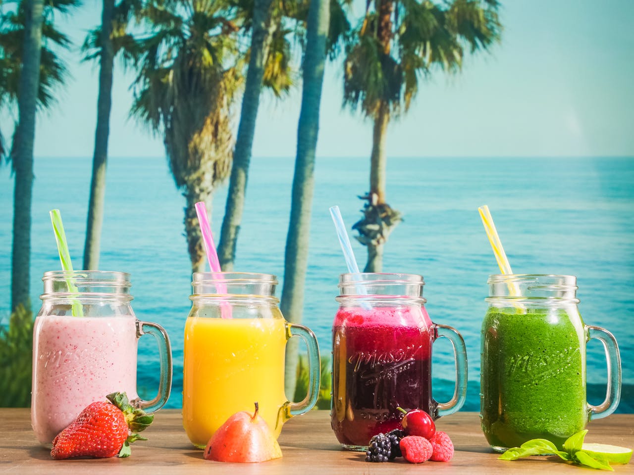 why-choose-us Vibrant smoothies in mason jars with a tropical ocean backdrop, perfect for refreshment.